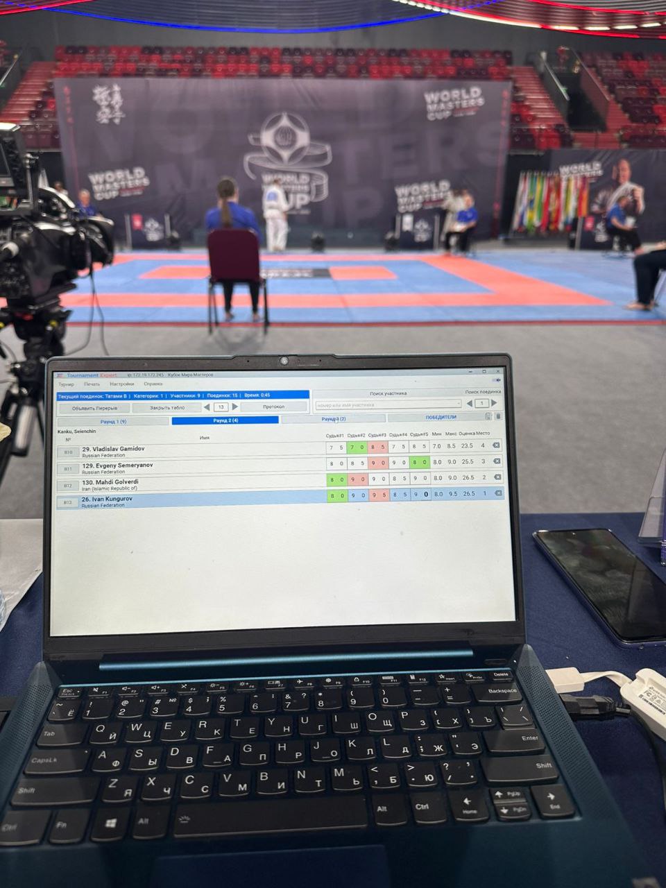 The working hall of the World Masters Cup 2025: the Tournament Expert scoreboard editor on a laptop and the arena